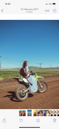 a woman is riding a dirt bike on an iphone